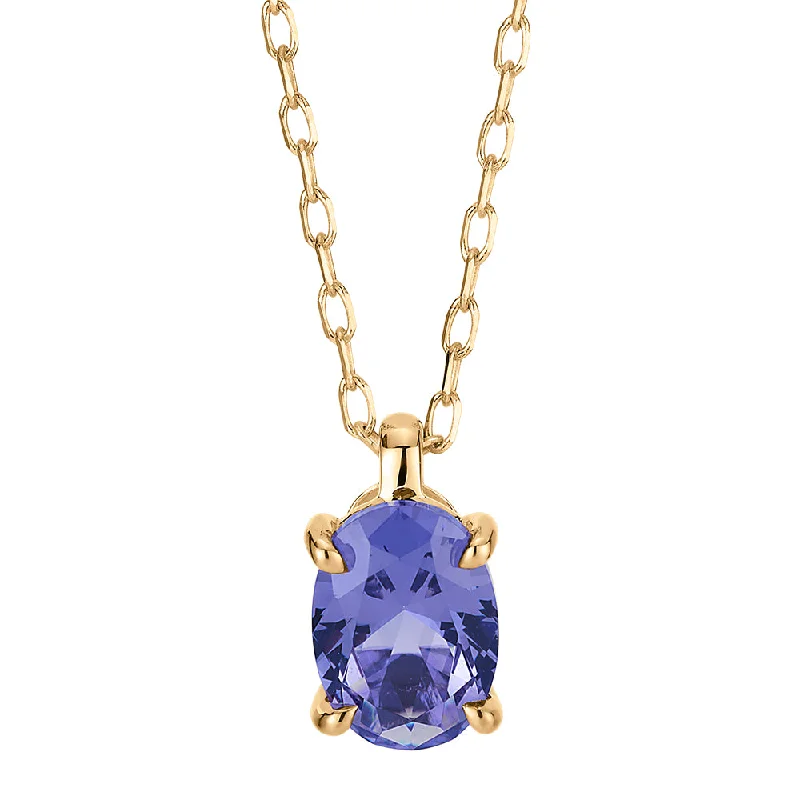 Oval solitaire pendant with tanzanite simulant in 10 carat yellow gold